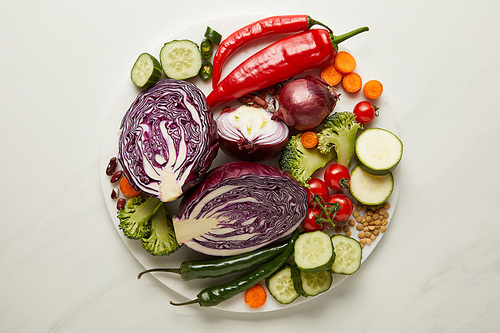 Top view of fresh vegetables and seeds on white surface