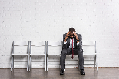 worried african american businessman waiting for job interview