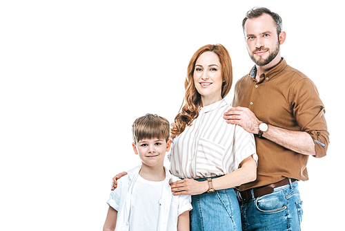 happy parents with cute little child standing together and smiling at camera isolated on white