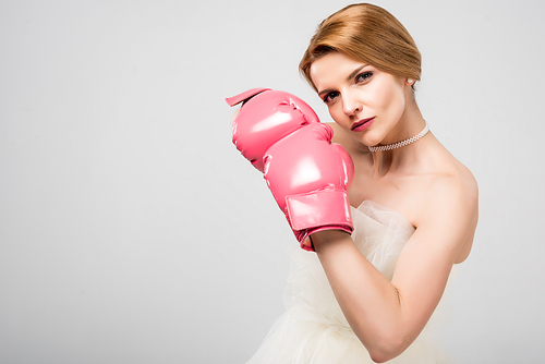 woman in white wedding dress and boxing gloves, isolated on grey, feminism concept