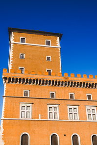bottom view of orange building and blue sky in Rome, Italy