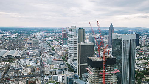 aerial view of cityscape with skyscrapers and buildings near crane in Frankfurt, Germany