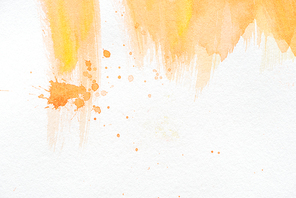 abstract orange watercolor painting with splatters on white paper
