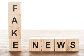 wooden cubes with words fake news on wooden tabletop