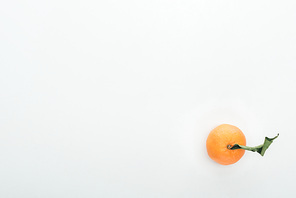 bright ripe orange tangerine with green leaves on white background with copy space