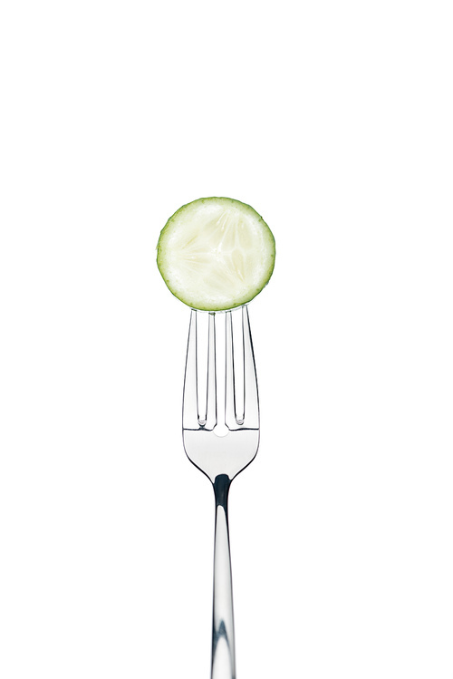 circle slice of fresh ripe cucumber on fork isolated on white