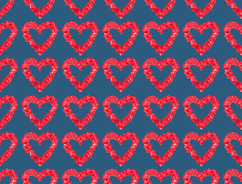 seamless pattern from beautiful decorative red hearts on blue background