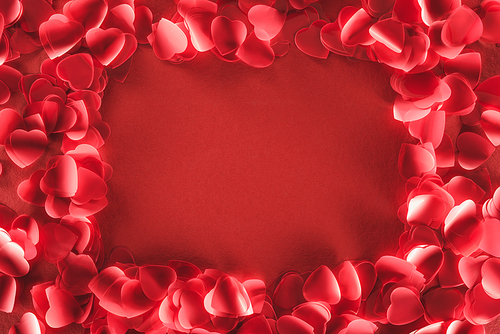 top view of decorative heart shaped petals on red background, valentines day concept