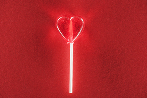 close-up view of heart shaped candy on red background