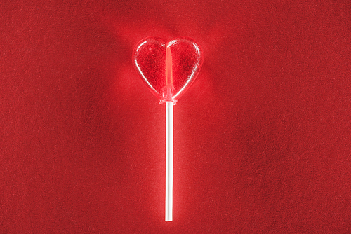 close-up view of heart shaped candy on red background