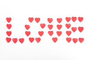 view from above of lettering love made of heart symbols isolated on white, st valentine day concept
