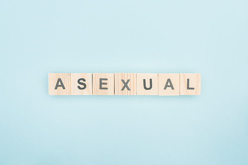 top view of asexual lettering made of wooden cubes on blue background