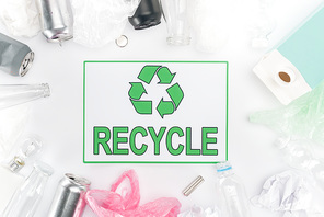 Cans, plastic and glass bottles, batteries, paper, bulb, carton bottle and plastic bags with recycling sign