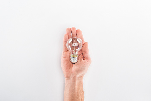 Partial view of man holding bulb on grey background