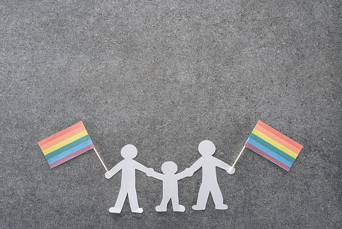 white paper cut same sex family with rainbow flags on grey background, lgbt concept