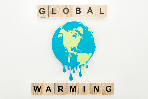 paper cut melting earth with global warming lettering on wooden cubes on grey background
