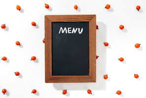top view of chalk board with menu lettering among cherry tomatoes