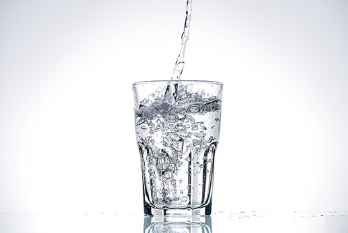 water pouring in  glass on white background with backlit and copy space
