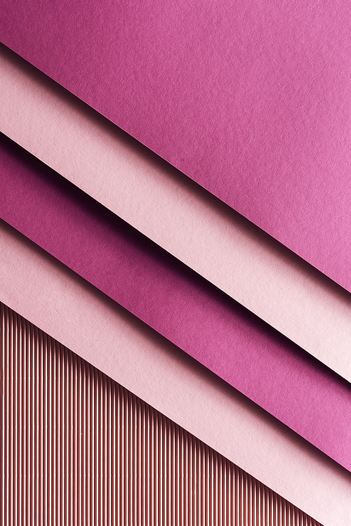 top view of pink and burgundy sheets of paper on pink background with copy space