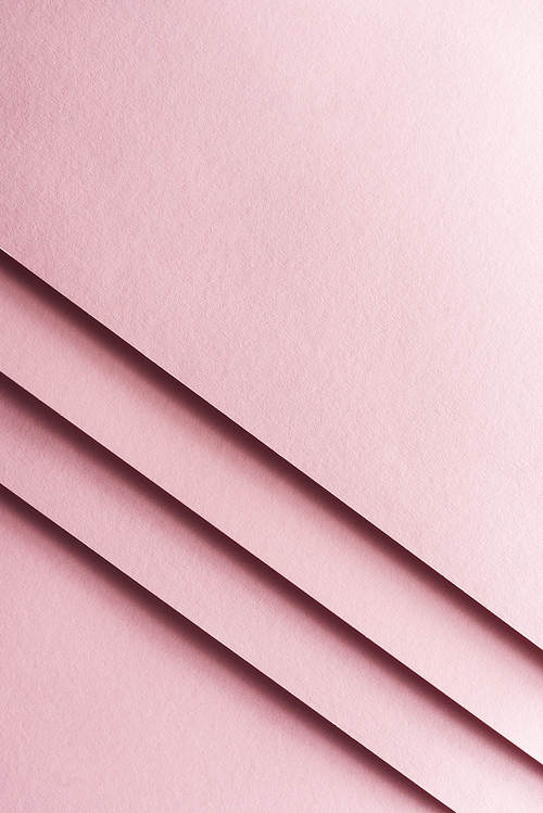 top view of empty and colorful sheets of paper on pink background with copy space