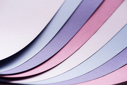 colorful blue, white, pink and purple sheets of paper with copy space