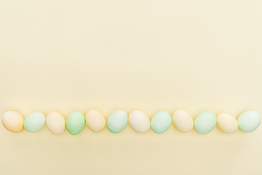 traditional pastel easter eggs in row isolated on yellow