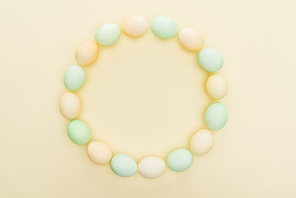 pastel easter eggs in circle frame isolated on yellow
