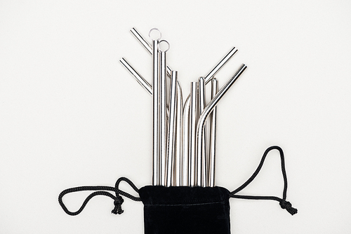 top view of stainless steel straws in black bag isolated on grey
