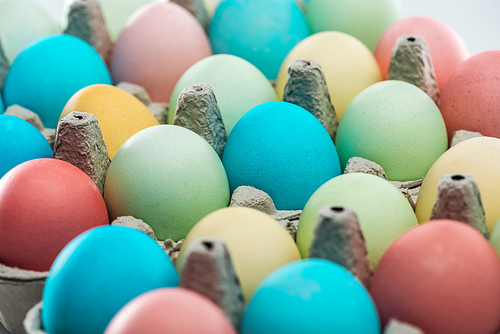 close up of colorful easter eggs in paper containers