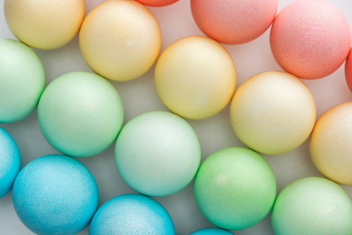 top view of colorful painted easter eggs on grey