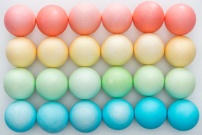 top view of colorful easter eggs on grey