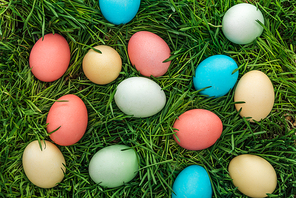 top view of traditional colorful easter eggs on green grass