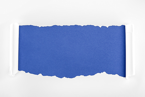 ragged textured white paper with curl edges on blue background