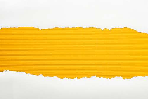 ripped white textured paper with copy space on yellow striped background