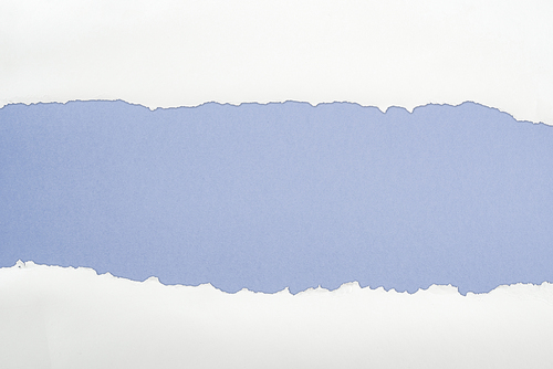 tattered white textured paper with copy space on blue background