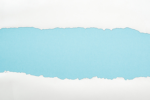 ragged white and textured paper with copy space on light blue background