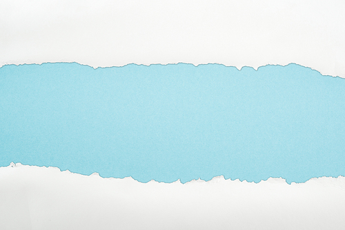 ragged white and textured paper with copy space on light blue background