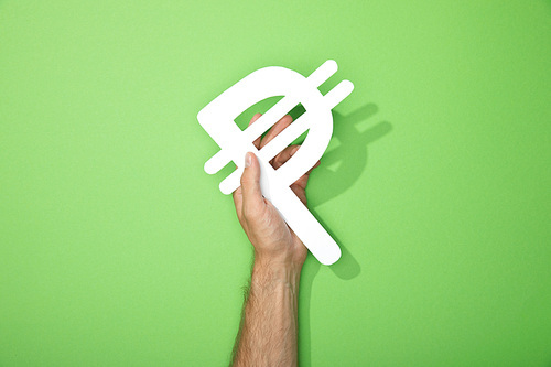 cropped view of man holding white peso currency sign on green