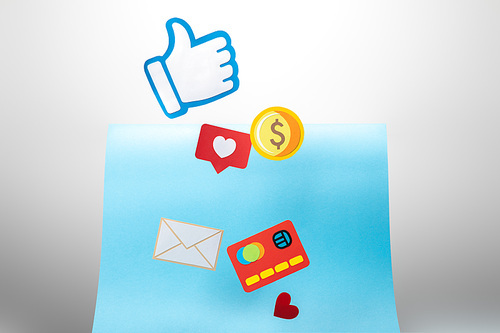 colorful paper icons and thumb up on white background