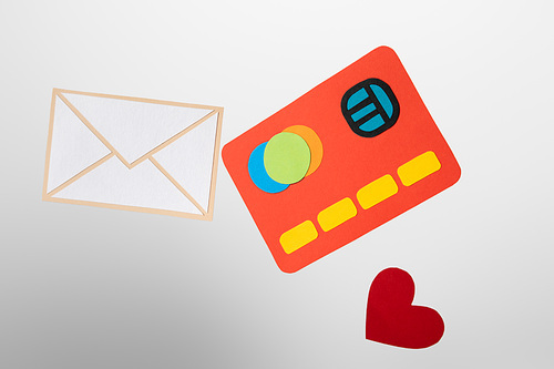 paper icons of credit card, envelope and heart on white and grey background