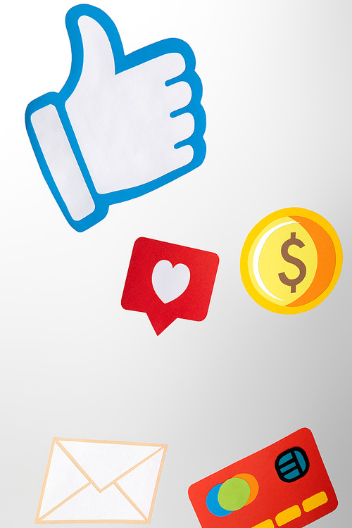 paper icons with envelope, coin, credit card, hearts and thumb up on white background