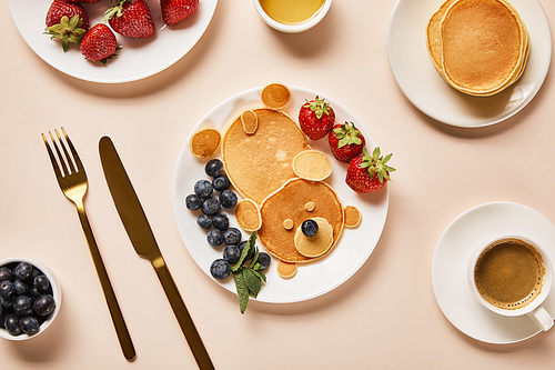 top view of pancakes with berries, honey and cup of coffee, bear concept