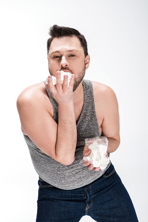 유토이미지 chubby man eating marshmallows and isolated on white