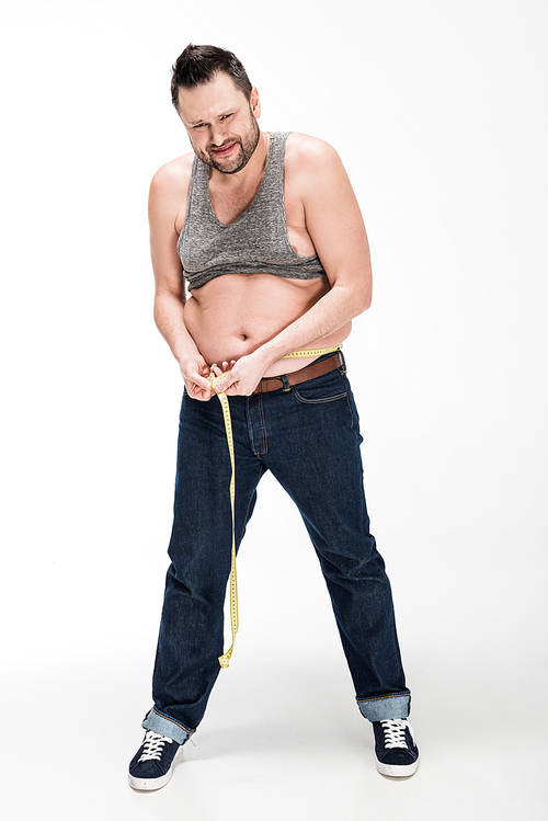 overweight man  and measuring waistline with tape on white