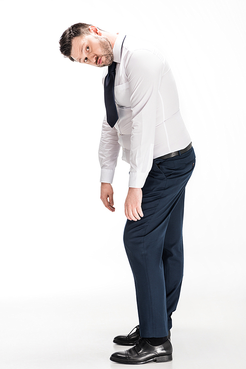 overweight man in tight formal wear  and bending over on white