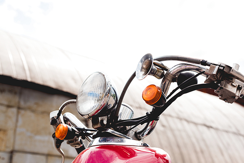 low angle view of red scooter on sky background