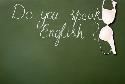 chalkboard with do you speak English lettering and bra