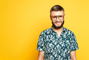 smiling bearded guy in glasses on yellow