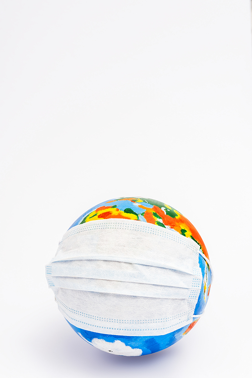 globe in protective medical mask on white with copy space