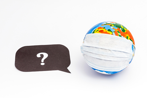 globe in medical mask near speech bubble with question mark on white